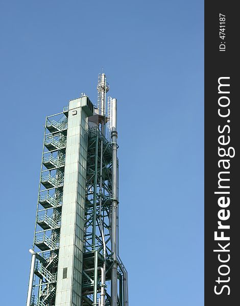 Chimney on a industrial building in blue sky. Chimney on a industrial building in blue sky