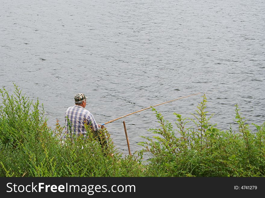 Fisherman on the river is to catching a fish. Fisherman on the river is to catching a fish
