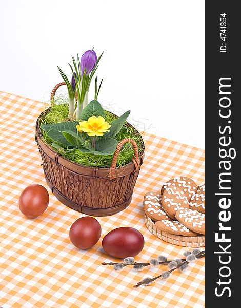 Easter eggs, flowers in a basket and cookies. Easter eggs, flowers in a basket and cookies