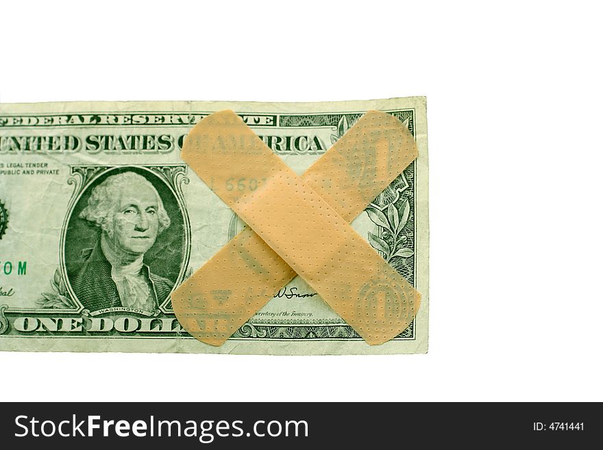 US dollar bill with two band aids on a white background. US dollar bill with two band aids on a white background