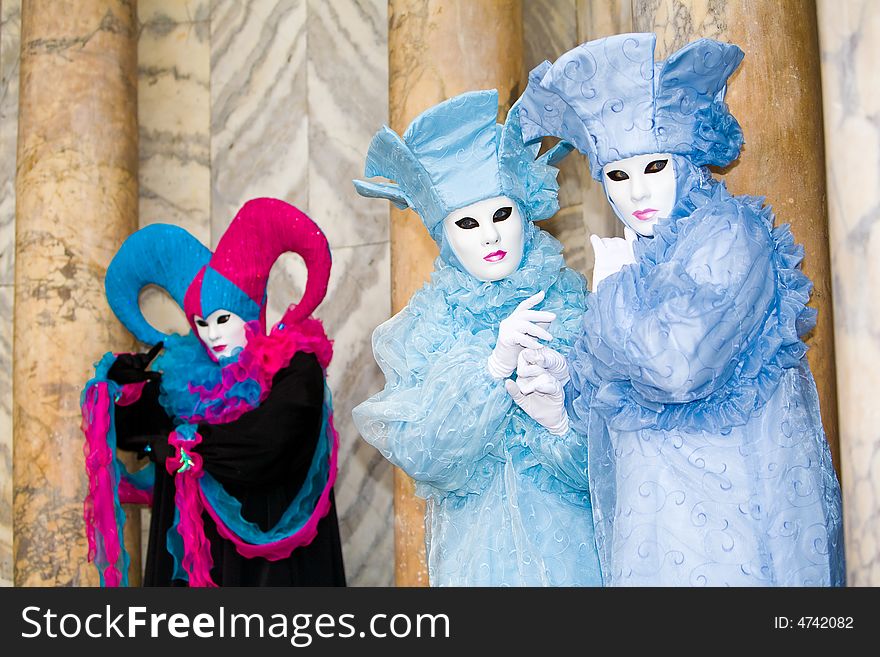 Three people in costume at the Venice Carnival. Three people in costume at the Venice Carnival