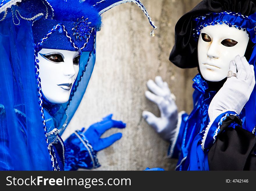 Two people in blue costumes at the Venice Carnival. Two people in blue costumes at the Venice Carnival