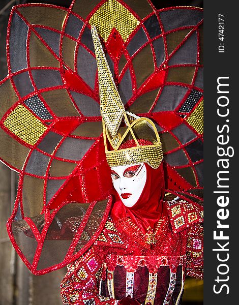 A fantastic red and gold costume at the Venice Carnival. A fantastic red and gold costume at the Venice Carnival