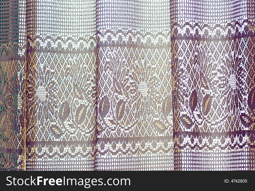 A piece of window curtain with embroidery flower patterns. A piece of window curtain with embroidery flower patterns.