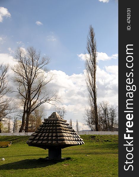 A view with an abstract wood sculpture outdoor. A view with an abstract wood sculpture outdoor