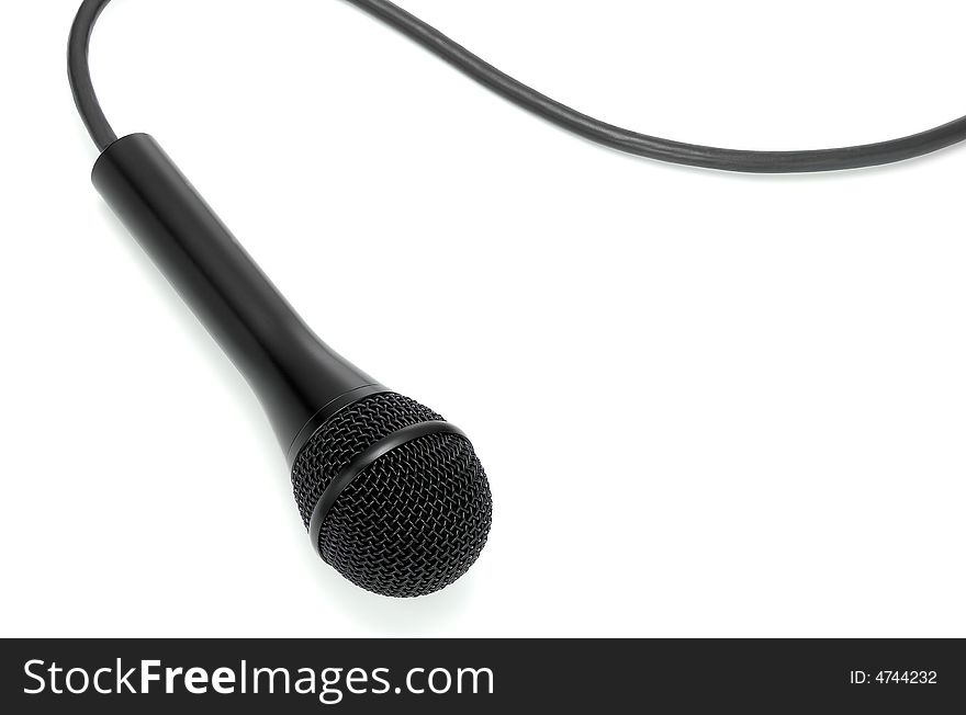 Classic black microphone lying on white from above