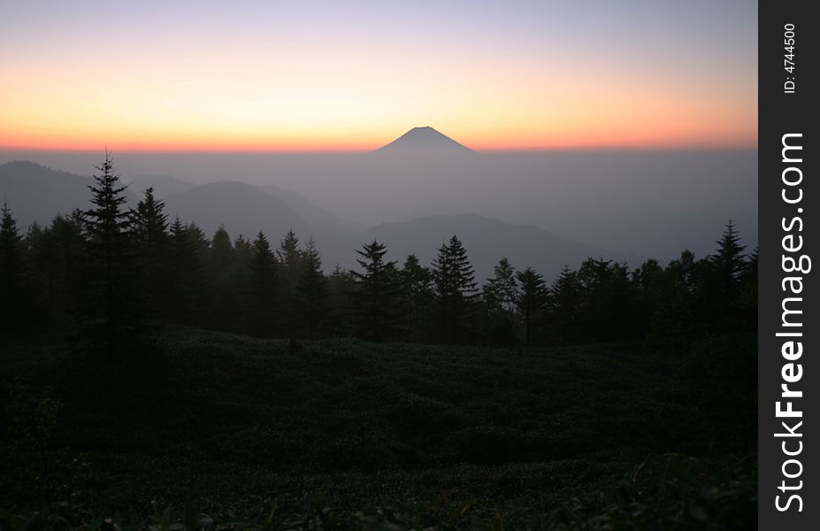 Majestic Mount Fuji rising through a sea of clouds. Majestic Mount Fuji rising through a sea of clouds