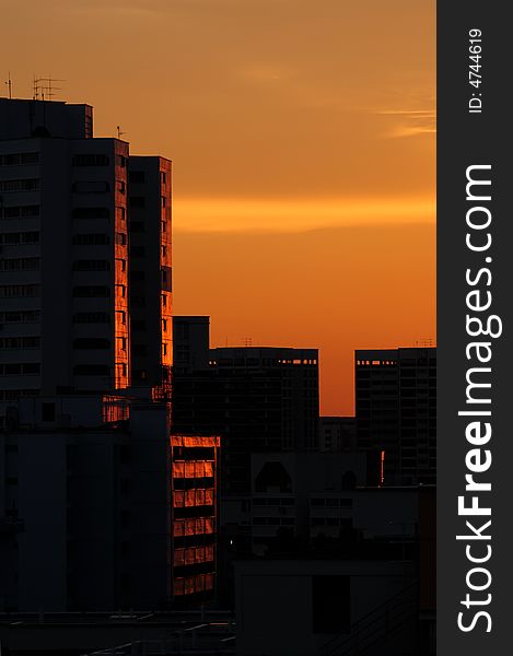 Tall building at sunset, enjoying the golden glow. Tall building at sunset, enjoying the golden glow