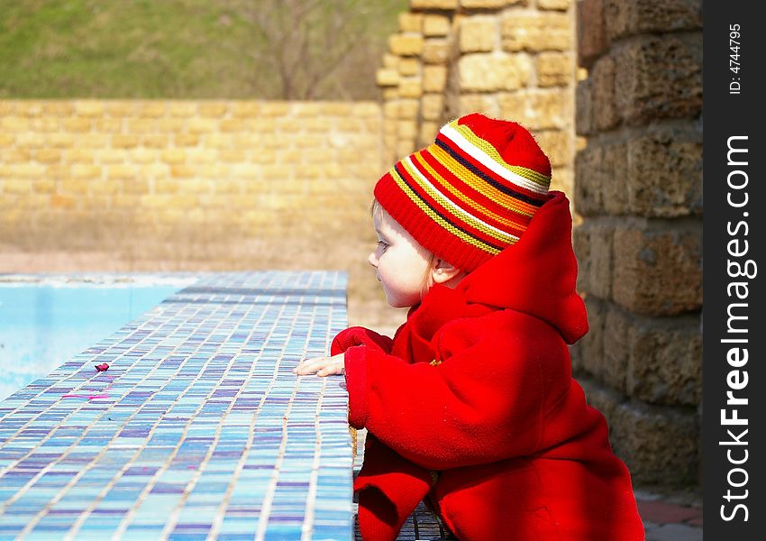 Little girl looks at the thrown pool