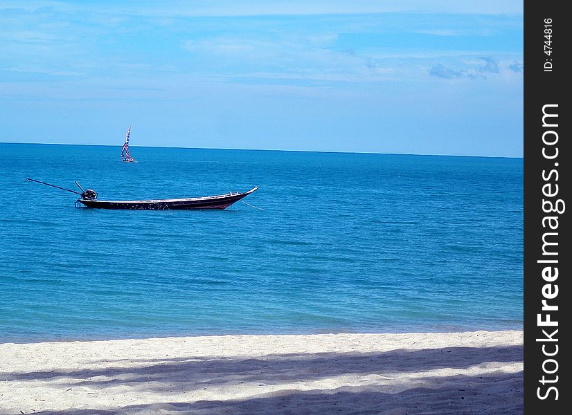 A longtail boat and a yacht, off Lamai Beach, Koh Samui, Thailand. A longtail boat and a yacht, off Lamai Beach, Koh Samui, Thailand