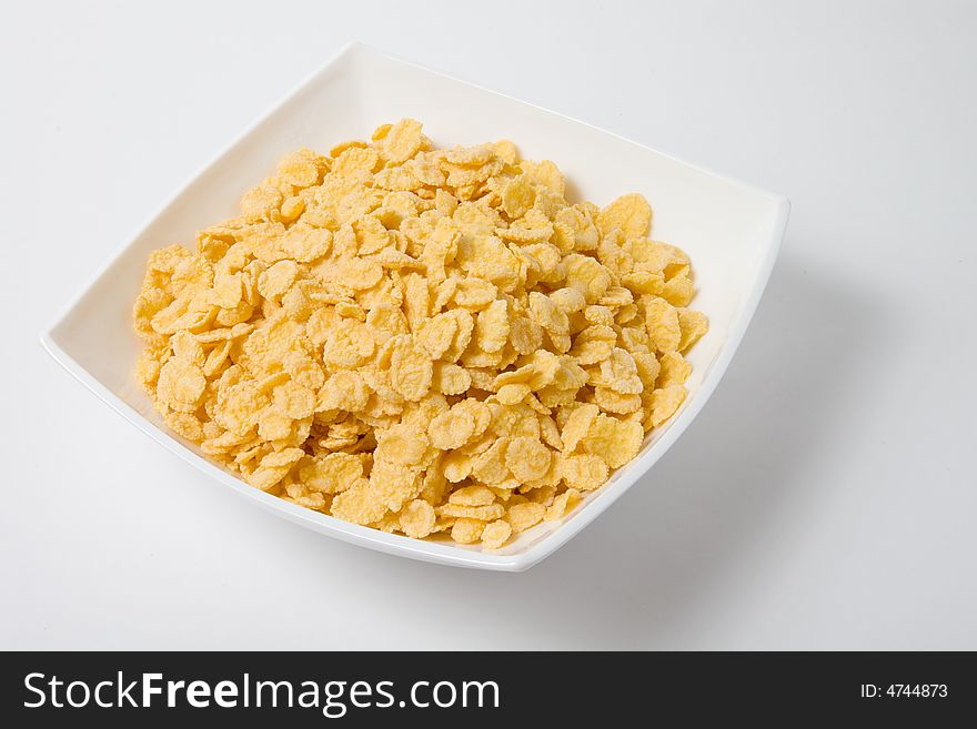 Bowl of flakes on white