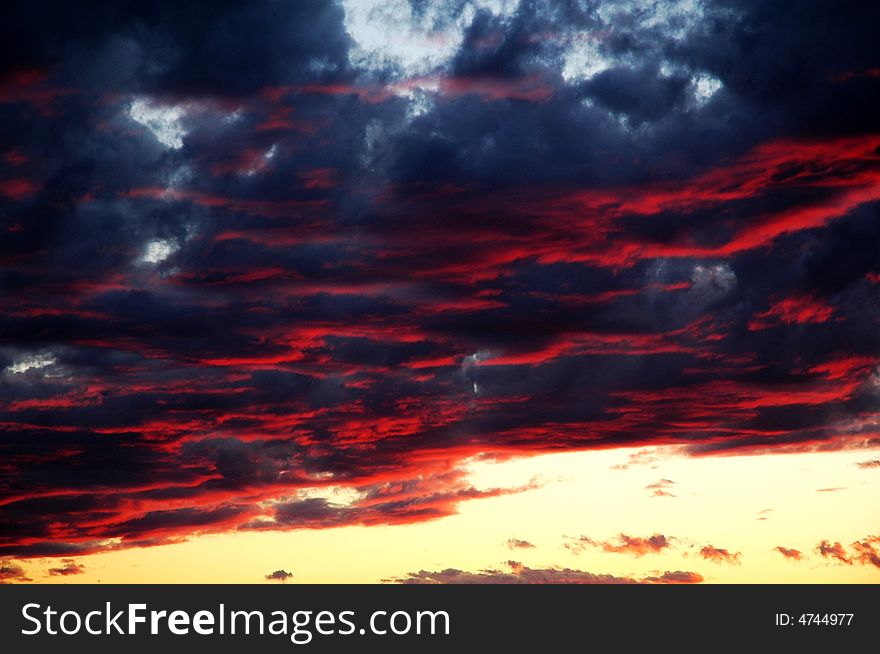 Fall shiny red sunset clouds and the earth