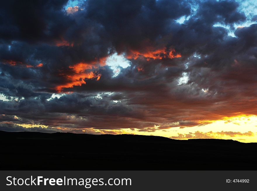 Fall shiny red sunset clouds and the earth