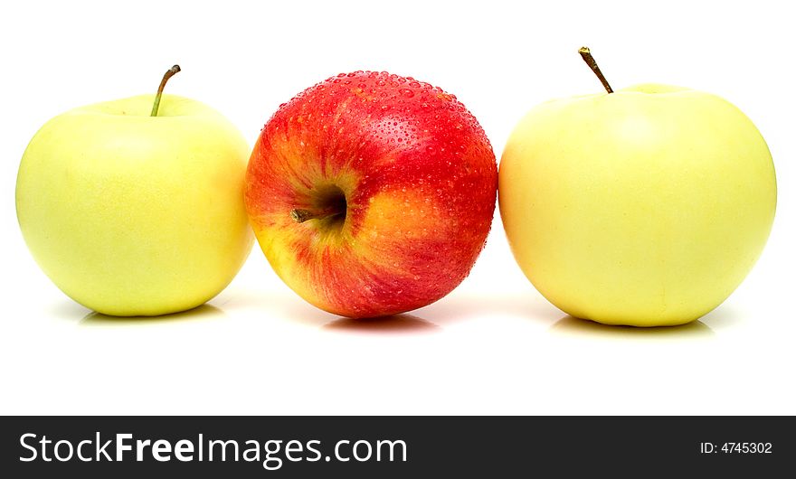 Red and yellow apples with water drops on the white background. Isolated.