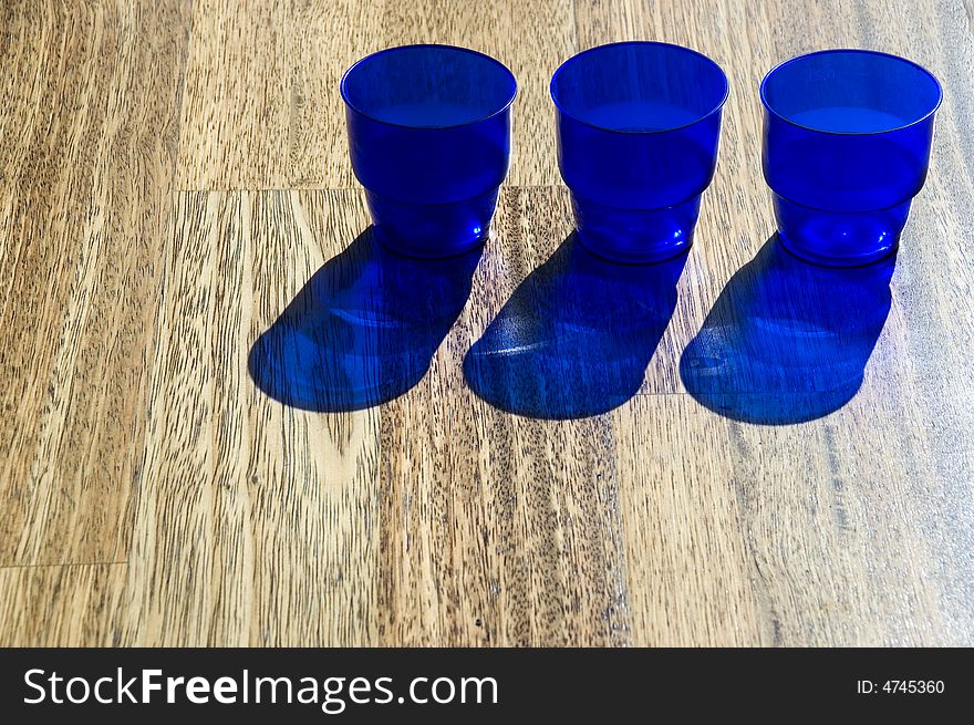 Dark blue utensils, shadow on a floor. Dark blue utensils, shadow on a floor.