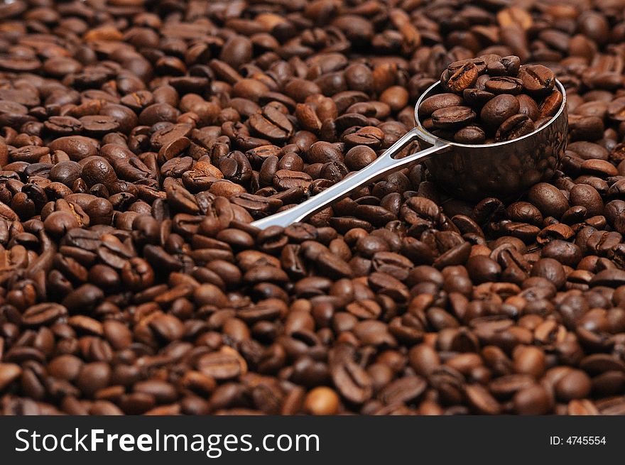 Coffee spoon lying on coffee beans. Coffee spoon lying on coffee beans