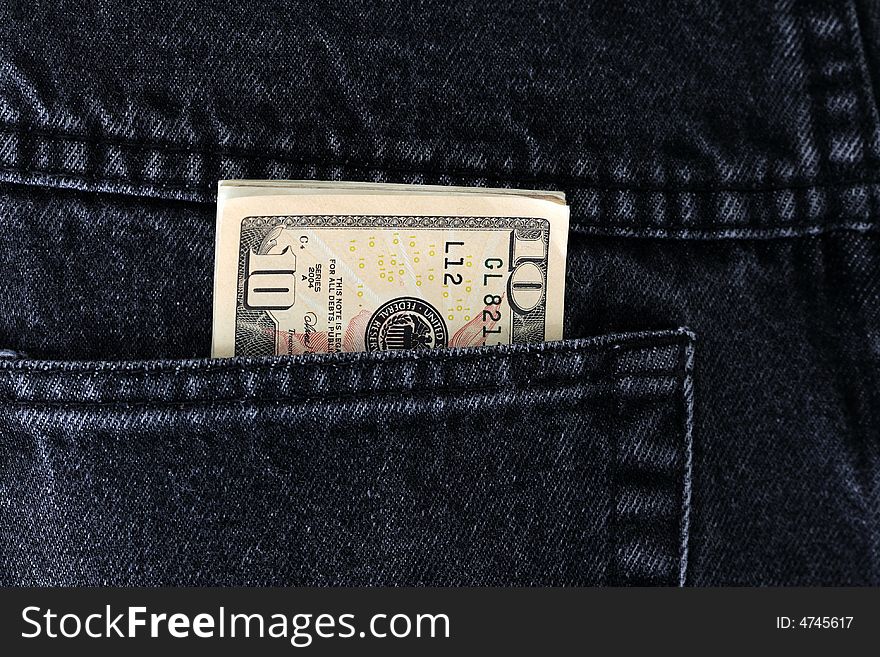 Dollar bills in the back pocket of a pair of denims. Dollar bills in the back pocket of a pair of denims.