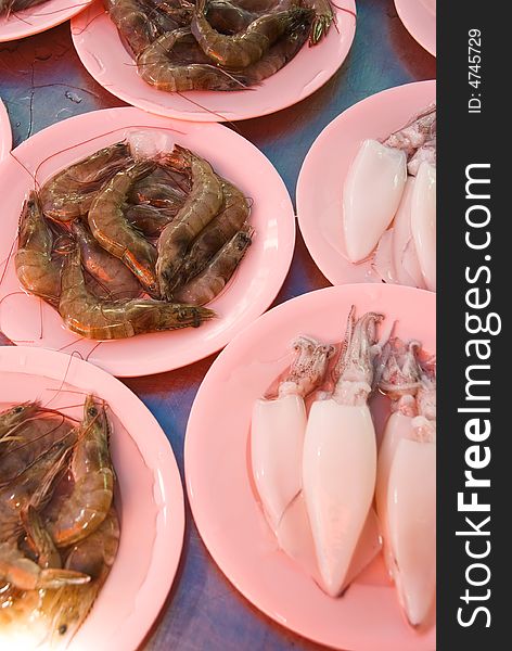 Seafood market for sale on pink plates