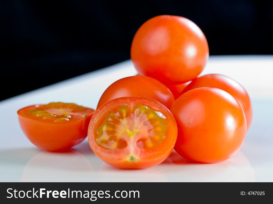 Fresh cherry- tomatoes on a white plate