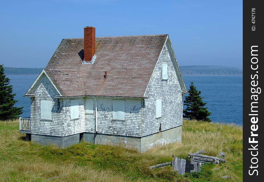 Old abandoned boarded up house, on Moshers Island Lighthouse Lahave Lunenburg County Nova Scotia Canada. Old abandoned boarded up house, on Moshers Island Lighthouse Lahave Lunenburg County Nova Scotia Canada