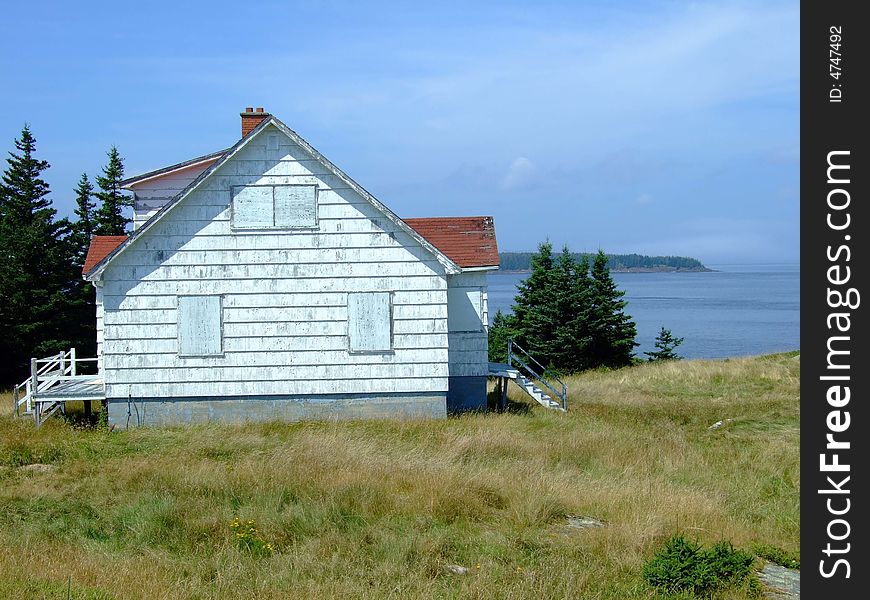 Old abandoned boarded up house, on Moshers Island Lighthouse Lahave Lunenburg County Nova Scotia Canada. Old abandoned boarded up house, on Moshers Island Lighthouse Lahave Lunenburg County Nova Scotia Canada