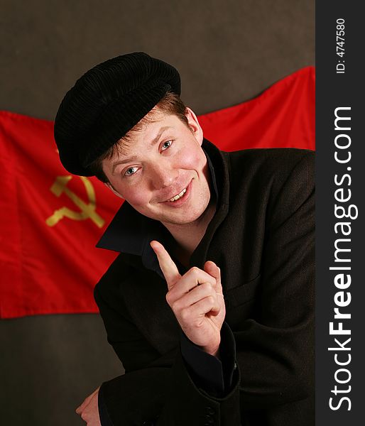 Portrait of the man in a cap on a background of a red flag. Portrait of the man in a cap on a background of a red flag