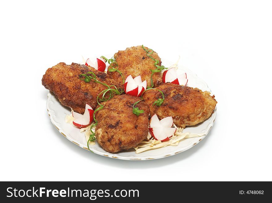 Meat rissoles with garden radish on a white round plate