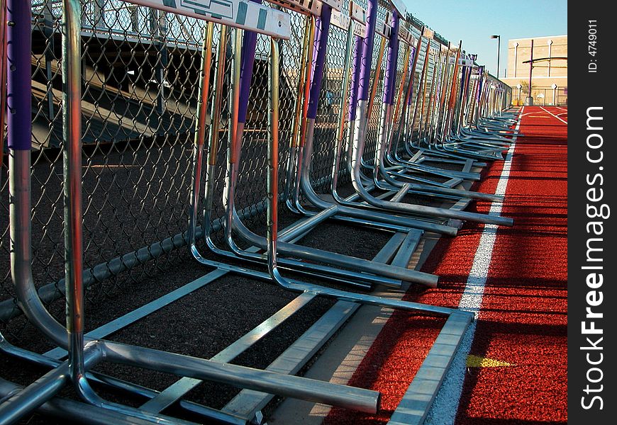 Shot of a black surfaced running track showing the lane markers of one through four and a grass covered infield. Shot of a black surfaced running track showing the lane markers of one through four and a grass covered infield.