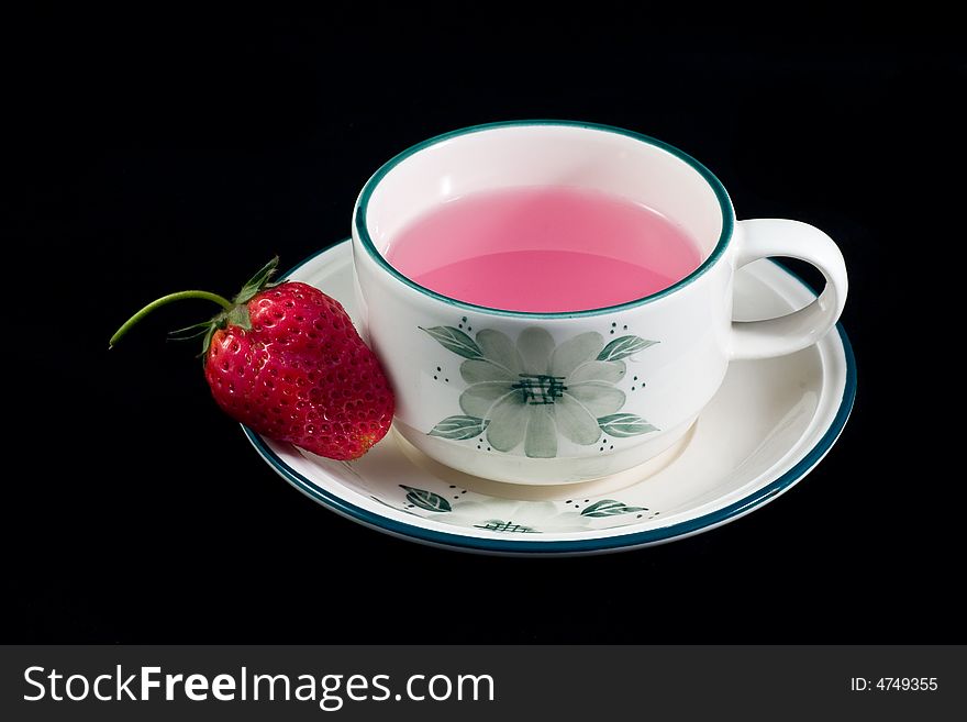 A cup of tea which made from strawberry. A cup of tea which made from strawberry
