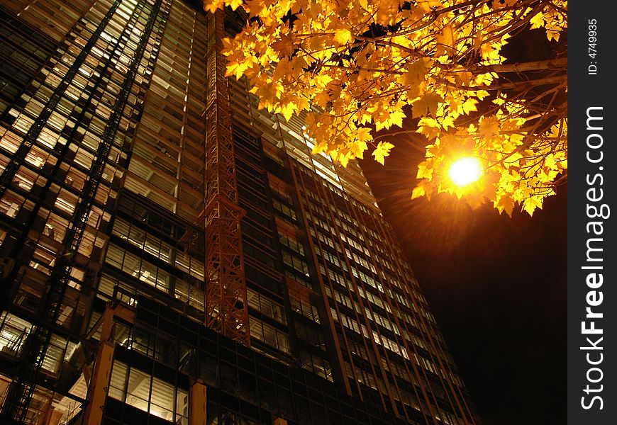 A picture of a building under construction taken at night,. A picture of a building under construction taken at night,