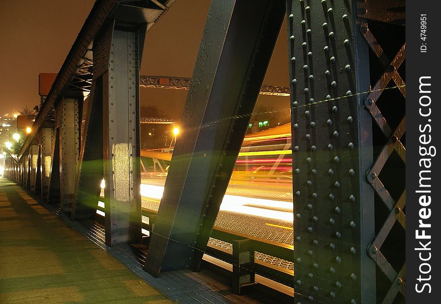 4 second exposure of car and bicycle traffic on a bridge. 4 second exposure of car and bicycle traffic on a bridge