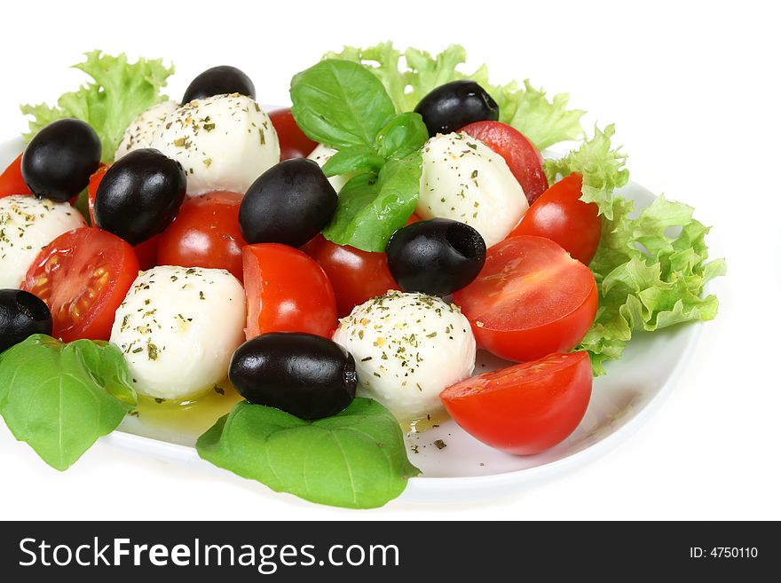 Caprese - Italian salad with cherry tomatos, olives and mozarella cheese. Caprese - Italian salad with cherry tomatos, olives and mozarella cheese