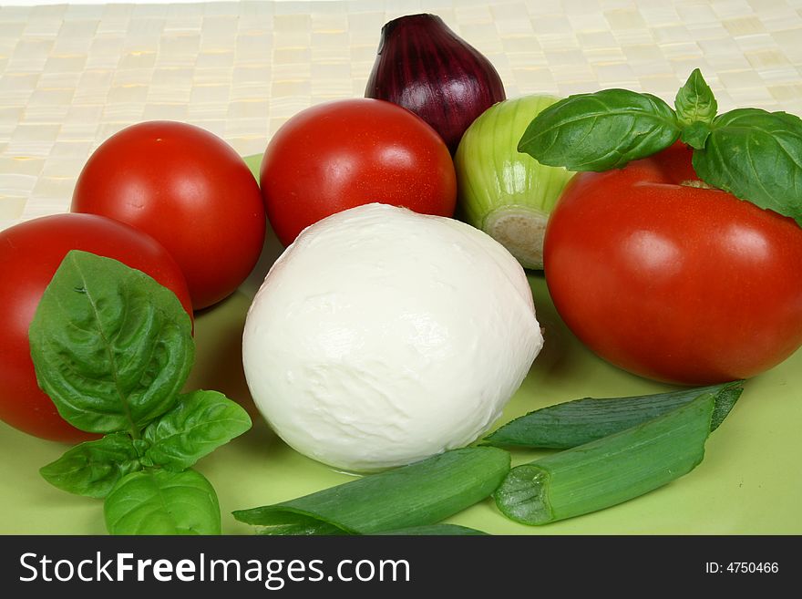 Caprese salad ingredients: tomatos, onions and mozarella cheese. Caprese salad ingredients: tomatos, onions and mozarella cheese