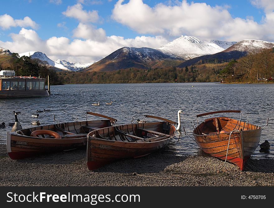 Wooden sailing boats resting on the lake side. Wooden sailing boats resting on the lake side