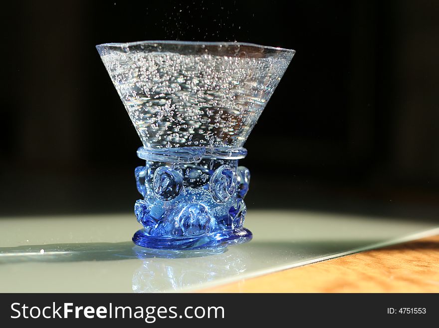 Mineral water in a figured hand-worked glass