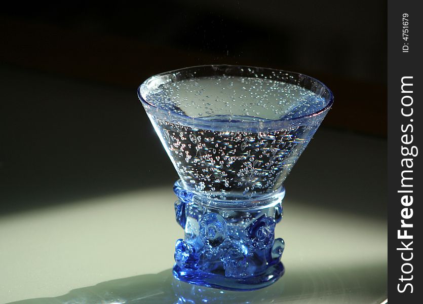 Mineral water in a figured hand-worked glass