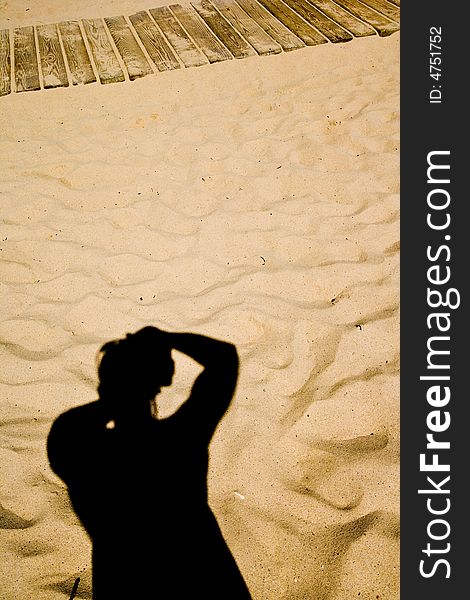 Shadow Of The Photographer Against A Sandy Beach