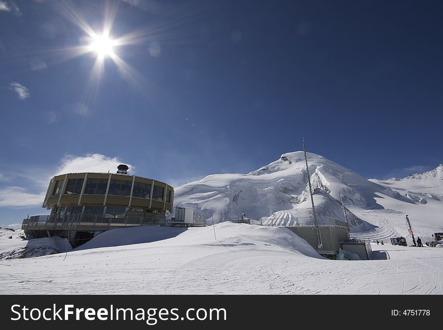 This photograph shows the top of a mountain in the resort of Saas-Fee in Switzerland. There are ski marks in the snow, and you can see down the valley over Saas-Fee and other mountain villages.

There is also a very interesting restaurant which inside has panoramic views over the valleys surrounding it. This photograph shows the top of a mountain in the resort of Saas-Fee in Switzerland. There are ski marks in the snow, and you can see down the valley over Saas-Fee and other mountain villages.

There is also a very interesting restaurant which inside has panoramic views over the valleys surrounding it.