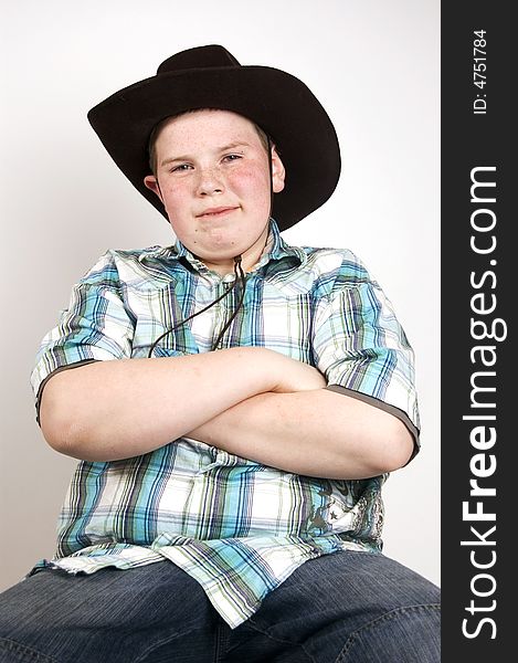 Young handsome cowboy sitting on a chair