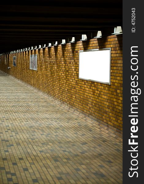 A Bricked Hallway With Blank Advertisement Boards