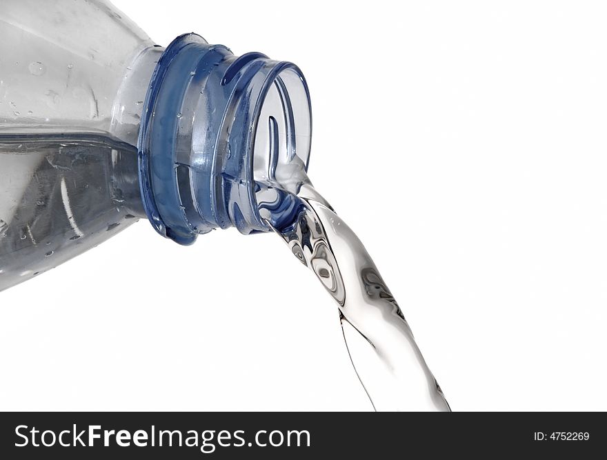 Fresh mineral water pouring from of a bottle