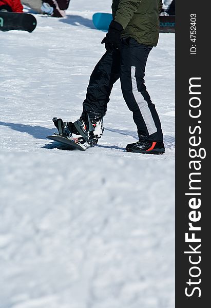 A Person Setting Up Their Snowboard