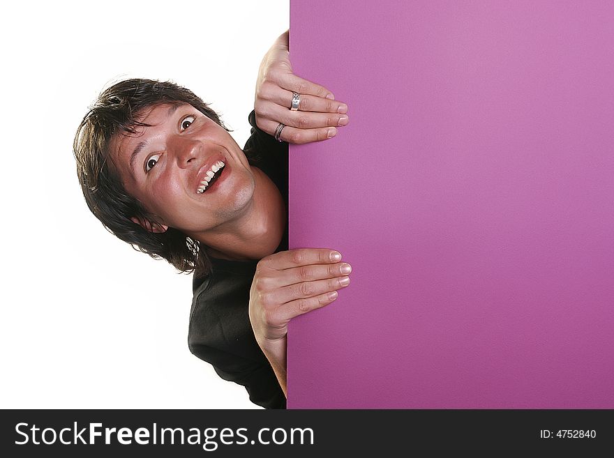 Attractive young man holding a purple billboard, studio shot. Attractive young man holding a purple billboard, studio shot