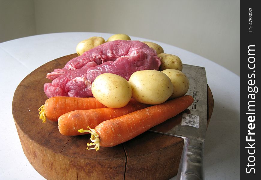 Preparing food, meat and vegetables, carrot, potato on a cutting board