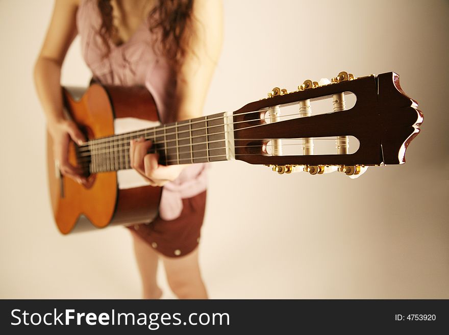 Girl playing classical guitar standing up. Girl playing classical guitar standing up