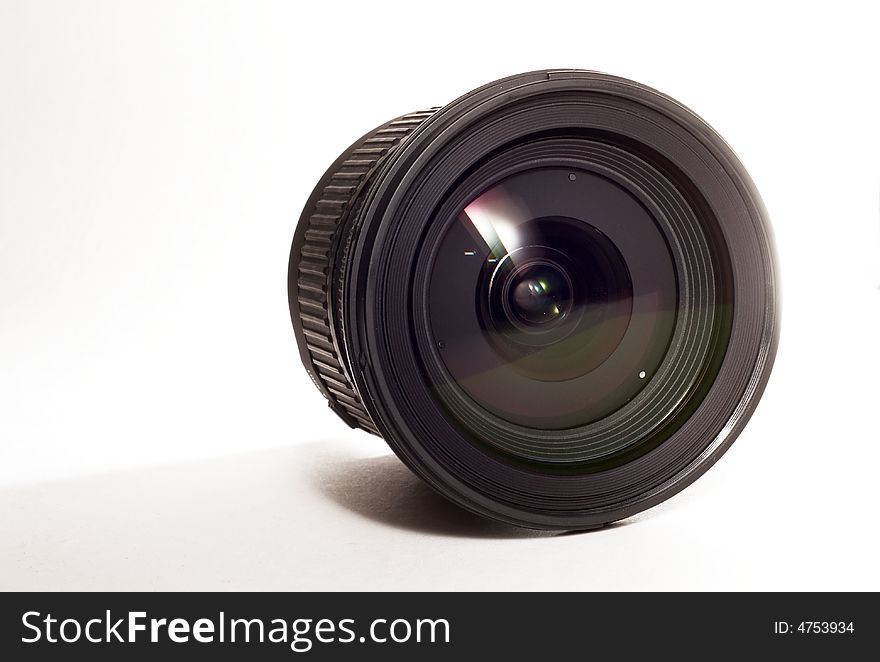 A camera lens focused on white isolated background. A camera lens focused on white isolated background.