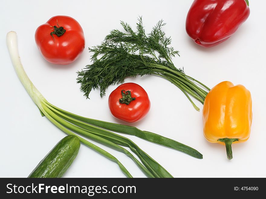 Multi-coloured vegetables for salad on a white background