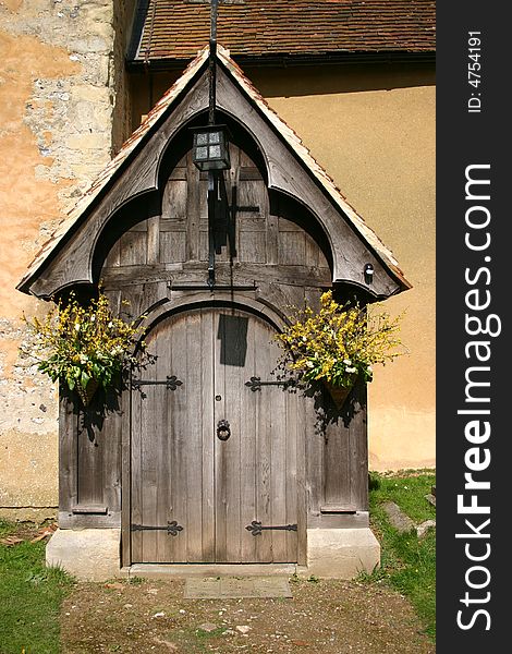 Flower decked ancient timber church entrance porch