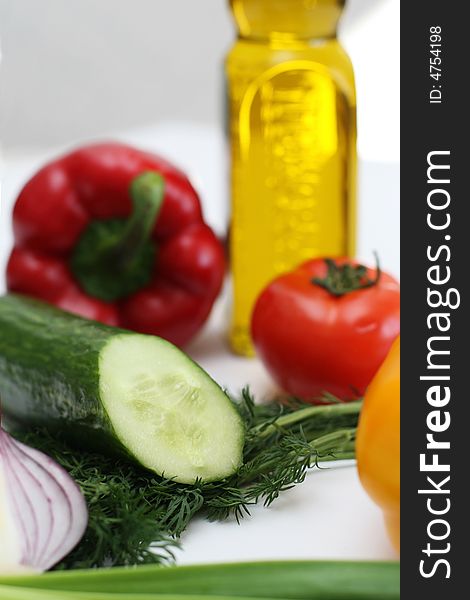 Multi-coloured vegetables for salad on a white background