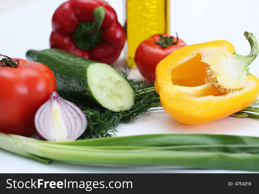 Multi-coloured vegetables for salad on a white background